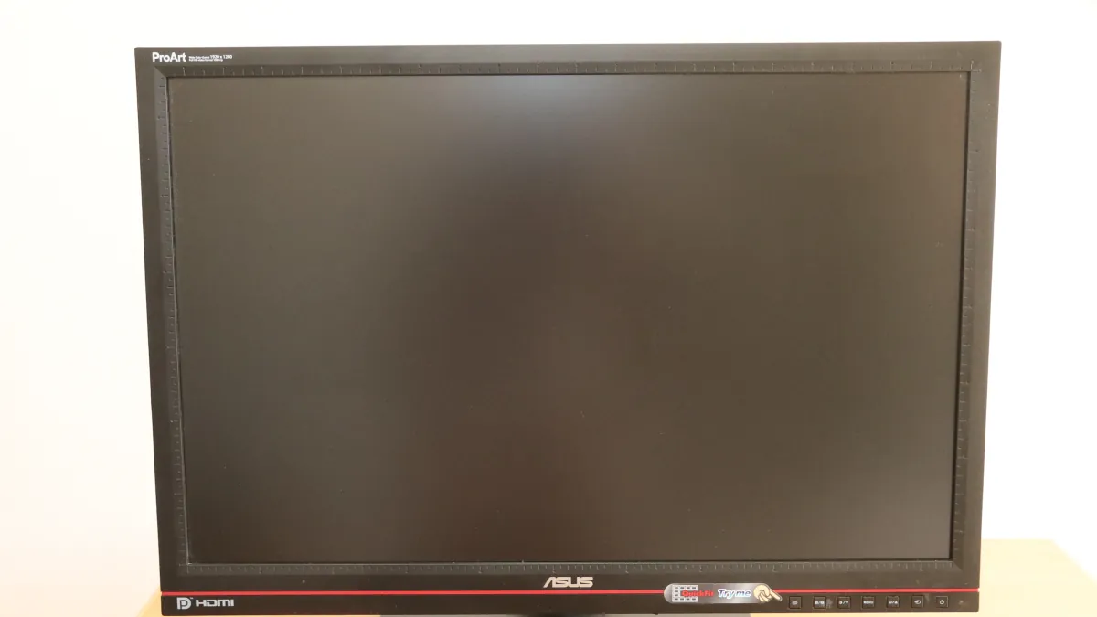 The dark screen and black frame of an older ASUS ProArt PA246Q monitor against a light background.
