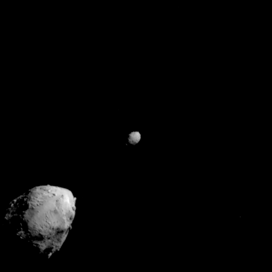 The larger asteroid Didymos at lower left and smaller Dimorphos at upper right against black space, observed before DART’s impact.