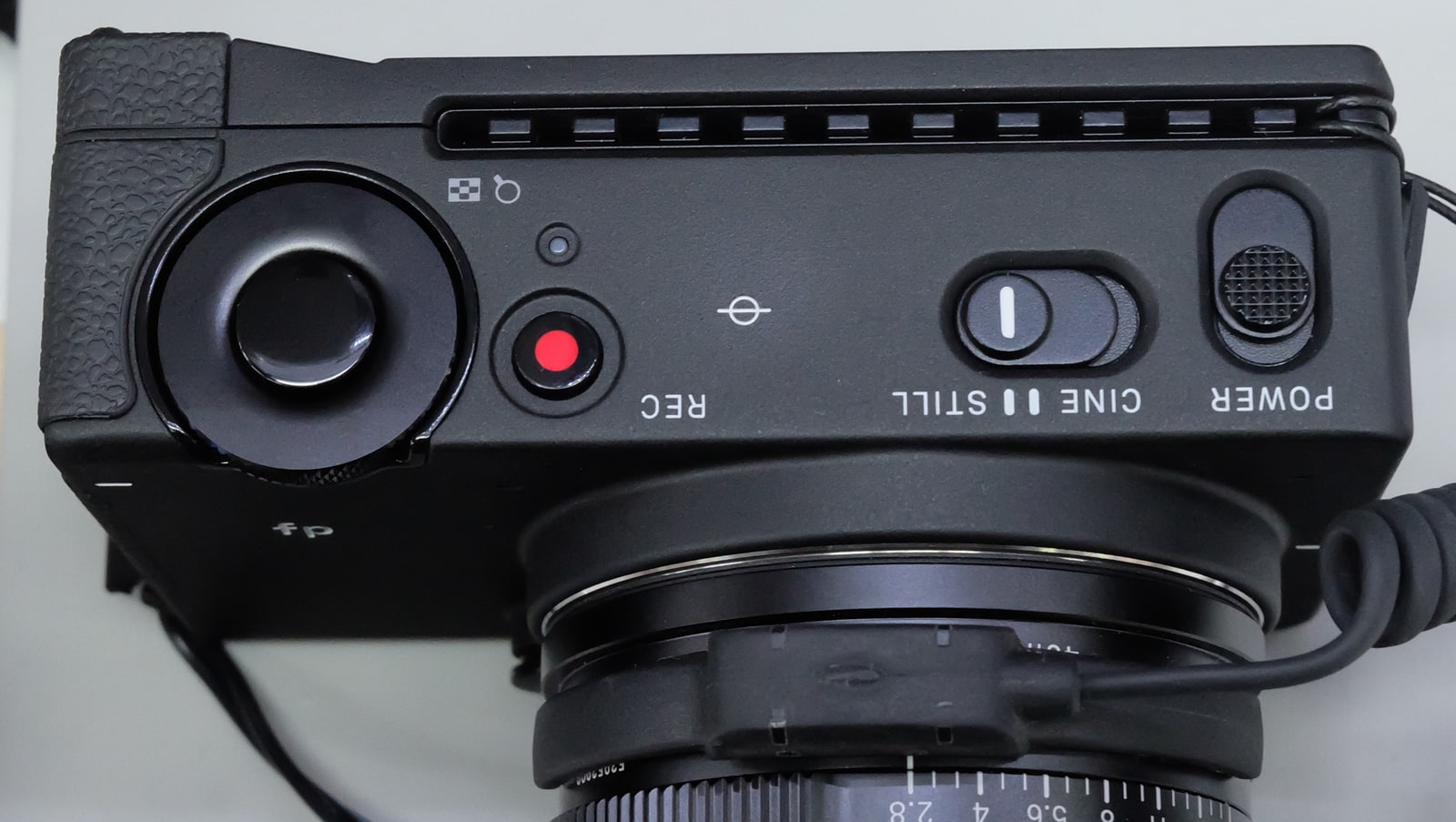 Archive photograph of the top controls and attached lens on an original Sigma fp, photographed in2019; not FP2.